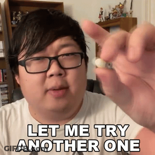 A Man With Glasses Holds A Pill In His Hand With The Words Let Me Try Another One Below Him GIF