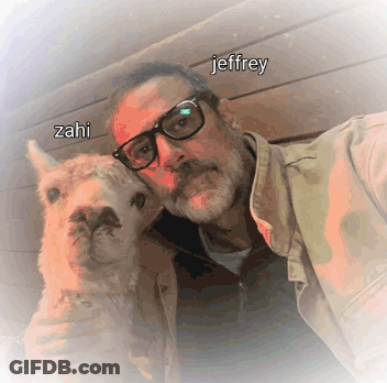 A Man With Glasses Holds A Small Animal With The Name Jeffrey Written On It GIF