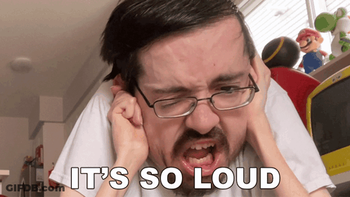 A Man With Glasses Is Covering His Ears And The Words It 'S So Loud Are Above Him GIF