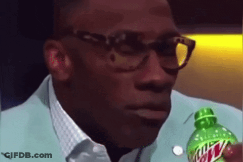 A Man With Glasses Is Holding A Bottle Of Mountain Dew . GIF
