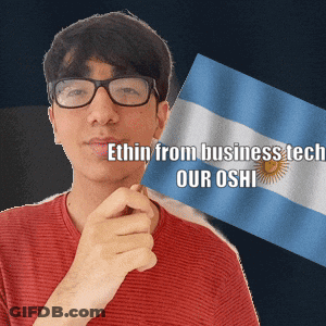 A Man With Glasses Is Holding A Flag With The Words " Ethin From Business Tech Our Oshi " Written On It GIF