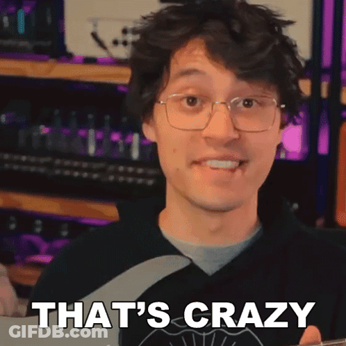 A Man With Glasses Is Holding A Guitar And Saying That 'S Crazy . GIF