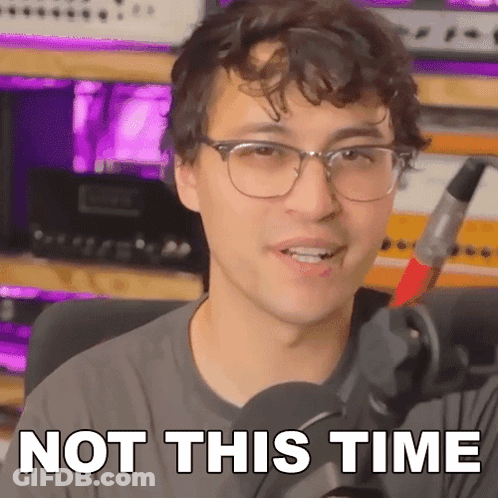 A Man With Glasses Is Holding A Microphone And Saying Not This Time . GIF