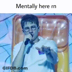 A Man With Glasses Is Holding A Microphone And Says Mentally Here Rn . GIF