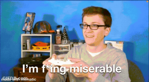 A Man With Glasses Is Holding A Video Game Controller And Says I 'M F * Ing Miserable Made With Mematic GIF
