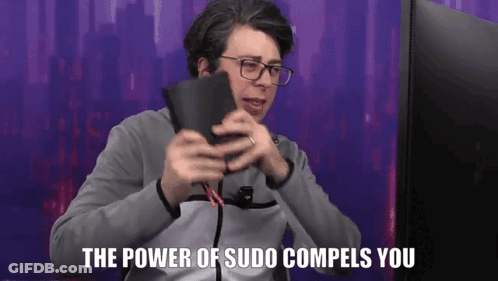 A Man With Glasses Is Holding A Wallet In Front Of A Computer Screen And Says The Power Of Sudo Compels You . GIF