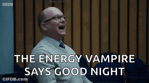 A Man With Glasses Is Laughing With The Words The Energy Vampire Says Good Night Behind Him GIF