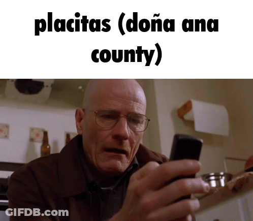 A Man With Glasses Is Looking At His Phone With The Words Placitas ( Doña Ana County ) Below Him GIF