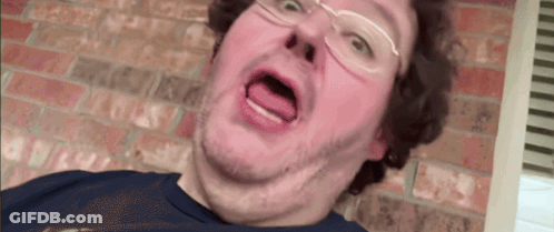 A Man With Glasses Is Making A Funny Face GIF