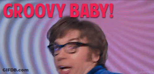 A Man With Glasses Is Making A Funny Face And The Words Groovy Baby Are Behind Him . GIF