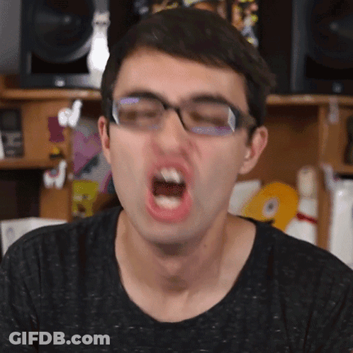 A Man With Glasses Is Making A Funny Face GIF