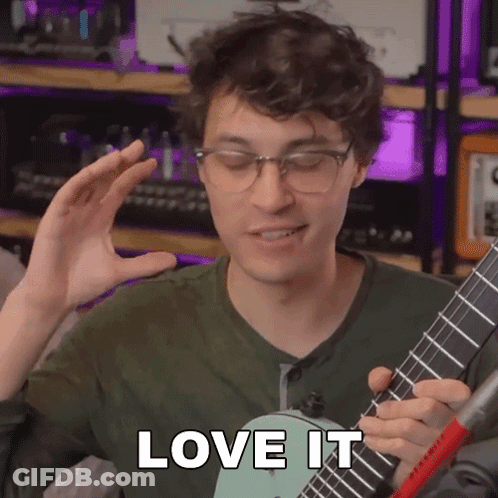 A Man With Glasses Is Playing A Guitar And Says Love It GIF