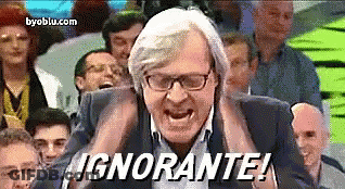 A Man With Glasses Is Screaming In Front Of A Crowd And The Words " Ignorante " Are On The Screen GIF
