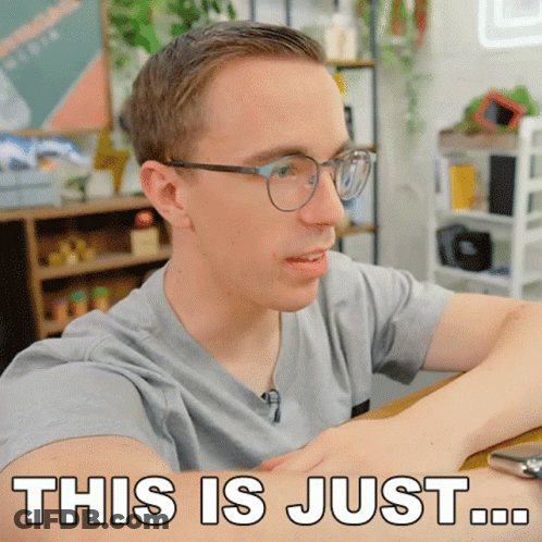 A Man With Glasses Is Sitting At A Table And Says " This Is Just " GIF