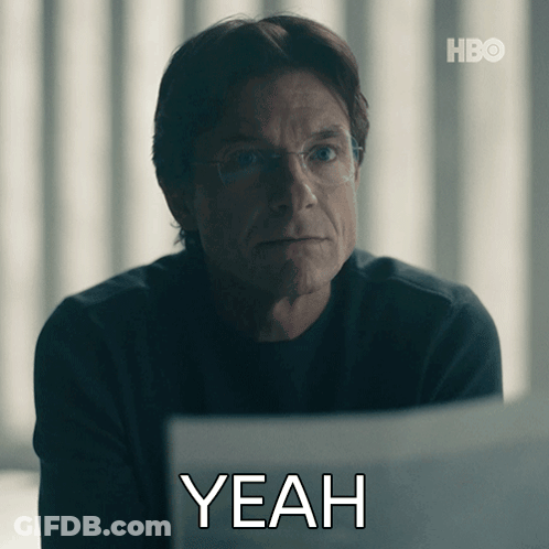 A Man With Glasses Is Sitting In Front Of A Laptop With The Word Yeah Written Below Him GIF