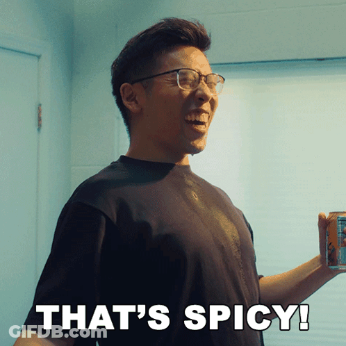 A Man With Glasses Is Smiling And Holding A Can Of Soda With The Words That 'S Spicy Below Him GIF