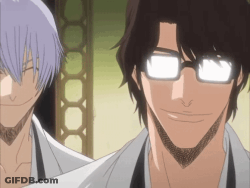 A Man With Glasses Is Smiling Next To Another Man With Purple Hair GIF