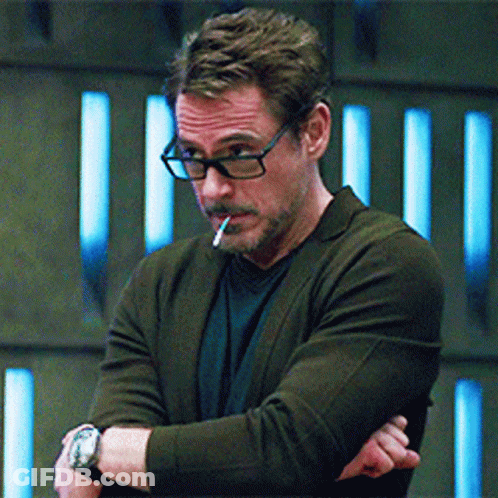 A Man With Glasses Is Smoking A Cigarette GIF