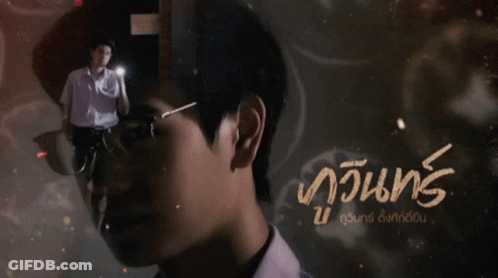 A Man With Glasses Is Standing In Front Of A Sign That Says ' Njung ' On It GIF