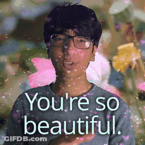 A Man With Glasses Is Surrounded By Pink Hearts And The Words You 'Re So Beautiful GIF