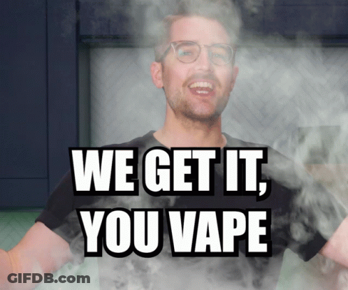 A Man With Glasses Is Surrounded By Smoke And The Words We Get It You Vape GIF