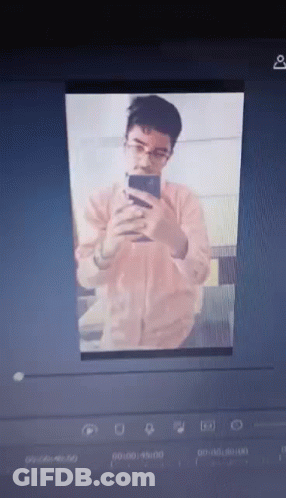 A Man With Glasses Is Taking A Selfie On His Phone GIF
