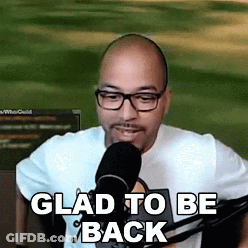 A Man With Glasses Is Talking Into A Microphone And Says Glad To Be Back . GIF