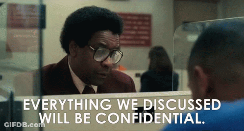 A Man With Glasses Looks At Himself In A Mirror With The Words Everything We Discussed Will Be Confidential Below Him GIF