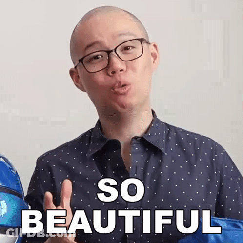 A Man With Glasses Says So Beautiful In Front Of A Blue Balloon GIF