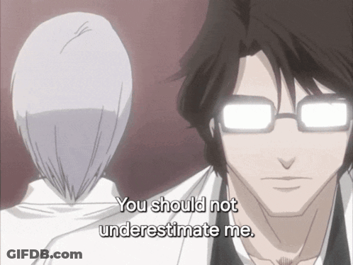 A Man With Glasses Says " You Should Not Underestimate Me " In Front Of A Woman GIF