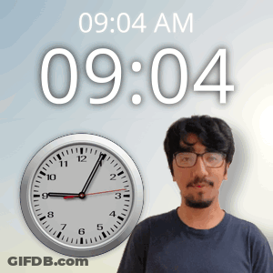 A Man With Glasses Stands In Front Of A Clock That Reads 9:04 Am GIF
