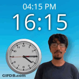 A Man With Glasses Stands In Front Of A Clock That Says 15:15 GIF