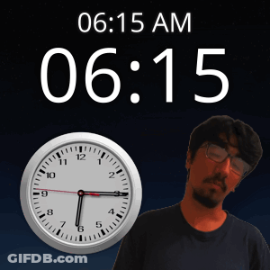 A Man With Glasses Stands In Front Of A Clock That Says 6:15 Am GIF