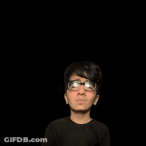A Man With Glasses Stands In Front Of A Green A GIF