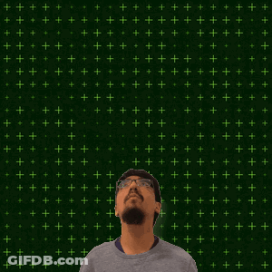 A Man With Glasses Stands In Front Of A Green Background With The Number 9 And 15 On It GIF