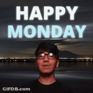 A Man With Glasses Stands In Front Of A Happy Monday Sign GIF