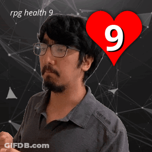A Man With Glasses Stands In Front Of A Red Heart With The Number 9 On It GIF