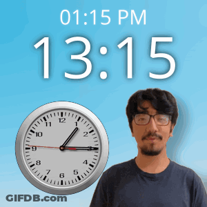 A Man With Glasses Stands In Front Of A Wall Clock That Says 13:15 GIF
