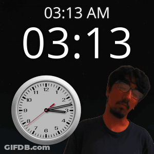 A Man With Glasses Stands Next To A Clock That Says 03 13 Am GIF