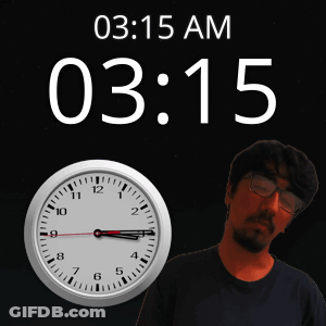 A Man With Glasses Stands Next To A Clock That Says 03:15 Am GIF