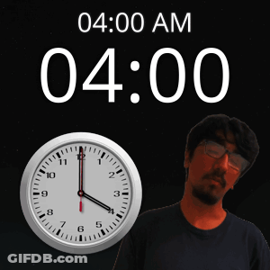 A Man With Glasses Stands Next To A Clock That Says 4:00 Am GIF