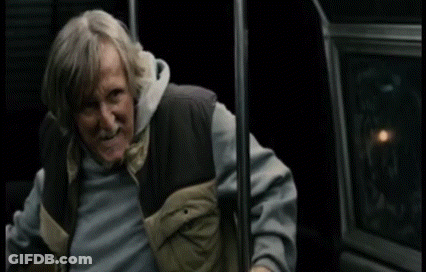 A Man With Gray Hair And A Beard Is Holding Onto A Railing With The Word Mcmuffin Written On It GIF