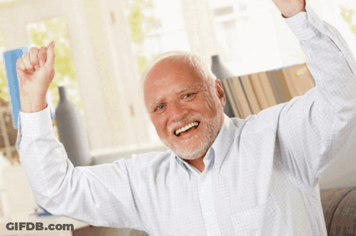 A Man With Gray Hair And A Beard Is Smiling With His Arms In The Air GIF