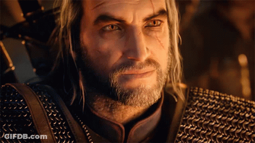 A Man With Gray Hair And A Beard Is Wearing A Chain Mail Jacket GIF