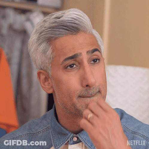 A Man With Gray Hair And A Beard Is Wearing A Denim Shirt And A Netflix Logo GIF