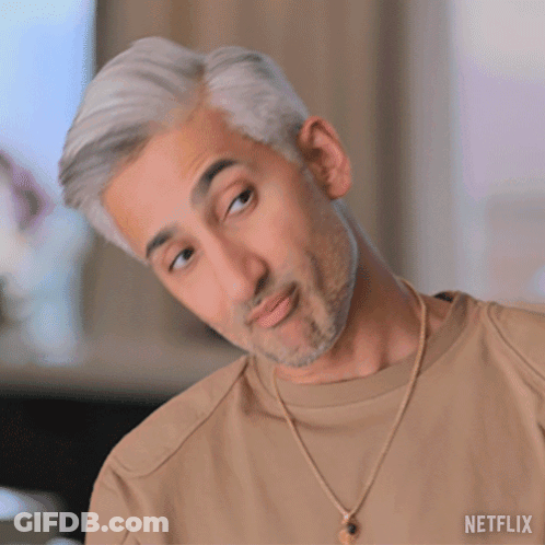 A Man With Gray Hair And A Beard Is Wearing A Tan Shirt And A Gold Necklace From Netflix GIF