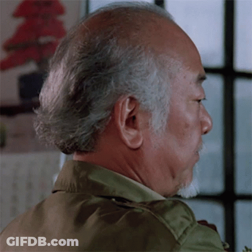 A Man With Gray Hair And A Beard Looks To His Left GIF