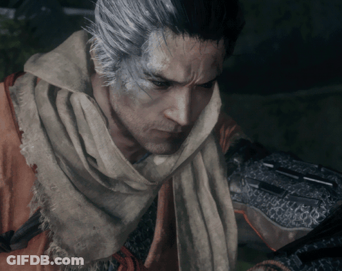 A Man With Gray Hair And A Scarf Around His Neck Looks At Something GIF