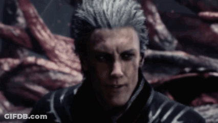 A Man With Gray Hair And Black Eyes Is Standing In A Dark Room Looking At The Camera . GIF