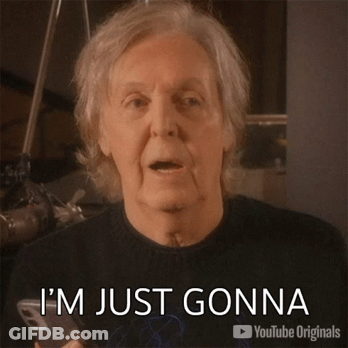 A Man With Gray Hair Is Pointing At A Cell Phone And Says Let It Be GIF